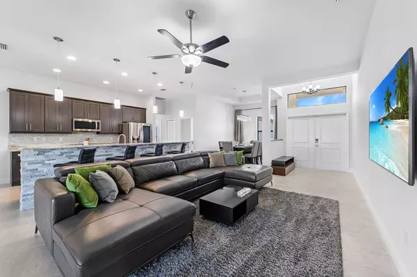 Bright Southwest Florida rental home living room with large windows and modern furniture.