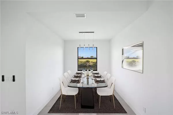 Bright flex space or home office in Cape Coral new construction home with modern tile floors, tall windows, and space for a desk or study area.