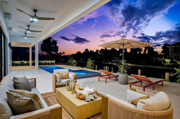 Marco Island luxury home with spa-inspired saltwater pool, waterfront patio, and sunset views