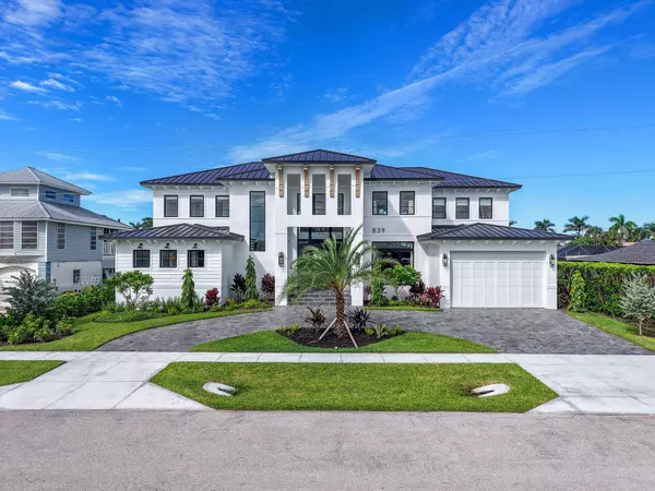 Marco Island brand new luxury waterfront estate with modern coastal architecture, metal roof, and two-car garage
