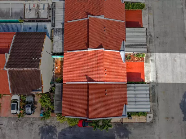 Aerial top view of Sweetwater Miami townhouse at 11217 SW 1st St #5 showing red tile Newer roof and two assigned front parking spaces.