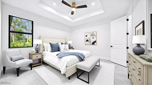 Virtually staged primary bedroom with tray ceiling, large window, and modern finishes in the Moon model home.