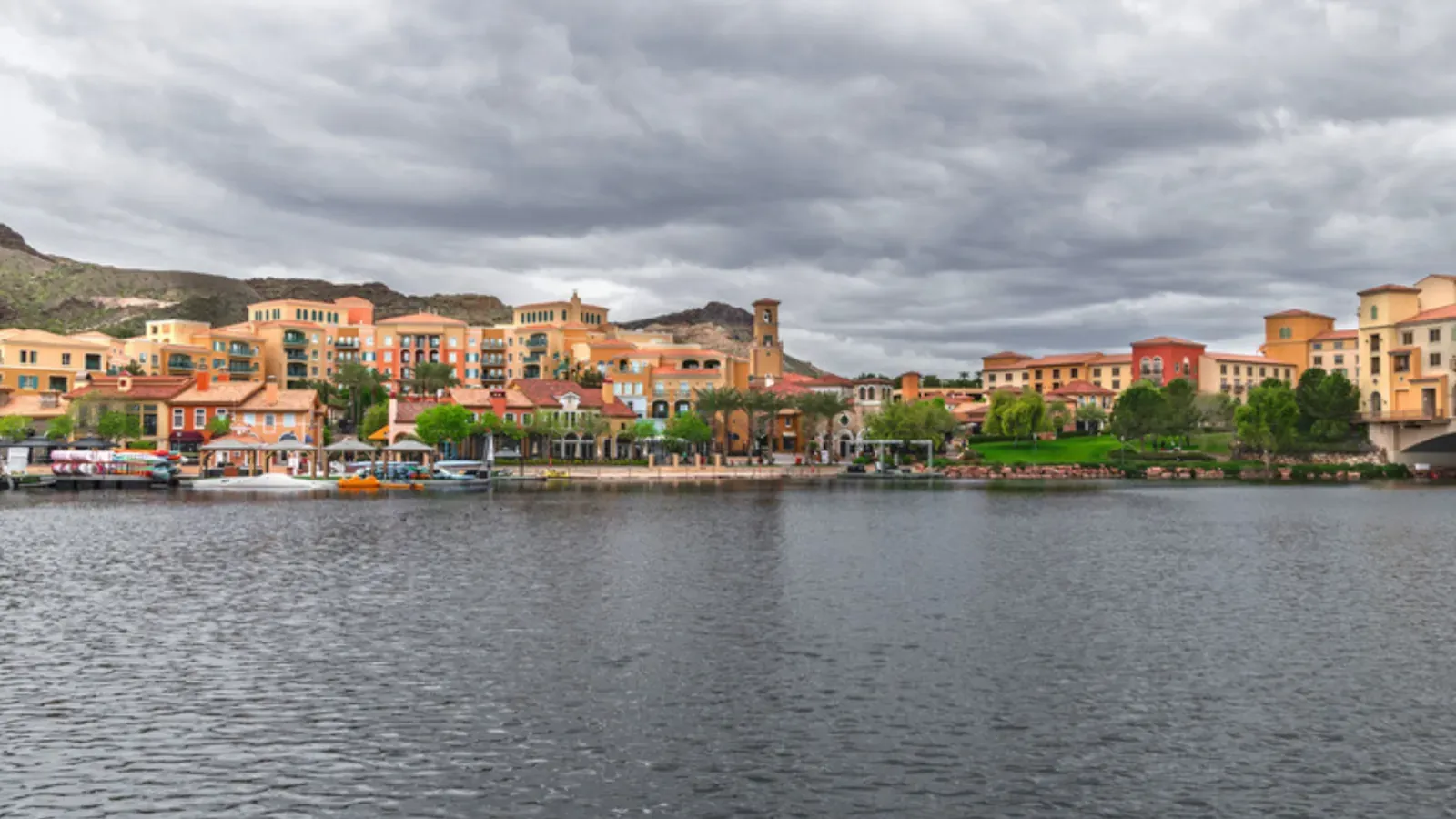 Waterfront homes along the Lake Las Vegas shore with desert hills behind