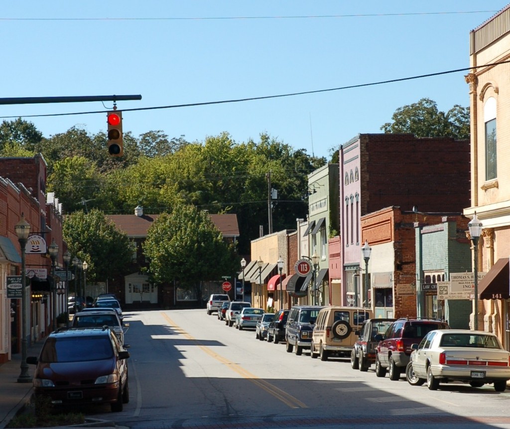 Downtown Seneca, South Carolina on a sunny day, featuring historic storefronts and parked cars—captured to showcase the charm of the area by Nakeshia Shannon, local Realtor serving the Upstate SC market.