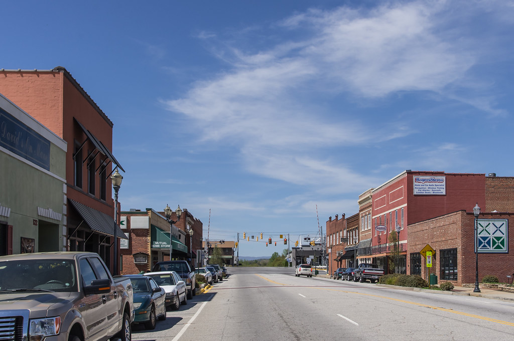 A vibrant view of downtown Easley, highlighting the main street lined with local shops and historic buildings. Realtor Nakeshia Shannon shares educational tips 