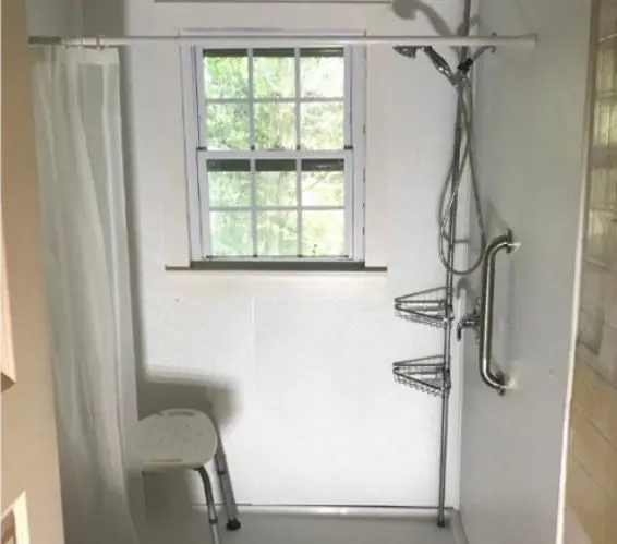 alt="Modern bathroom remodel with spacious shower, safety grab bar, and clean contemporary design"