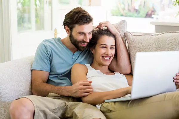 couple-sitting-on-sofa-and-using-laptop-2025-04-03-03-51-56-utc