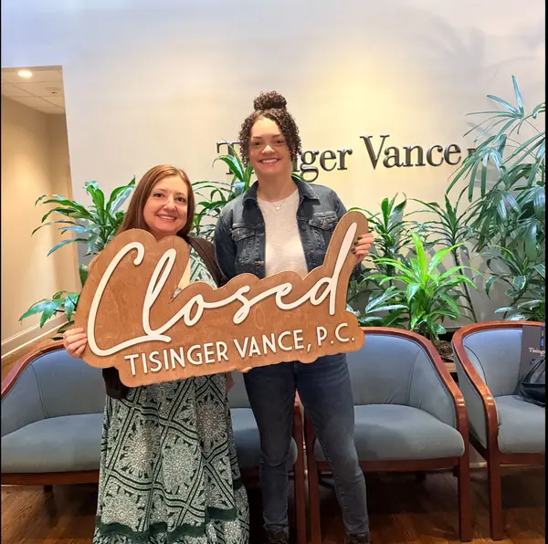 Sharon Bevins, Realtor, Carrollton GA Top Realtor, celebrating a successful home closing in Carrollton. with a happy buyer client.