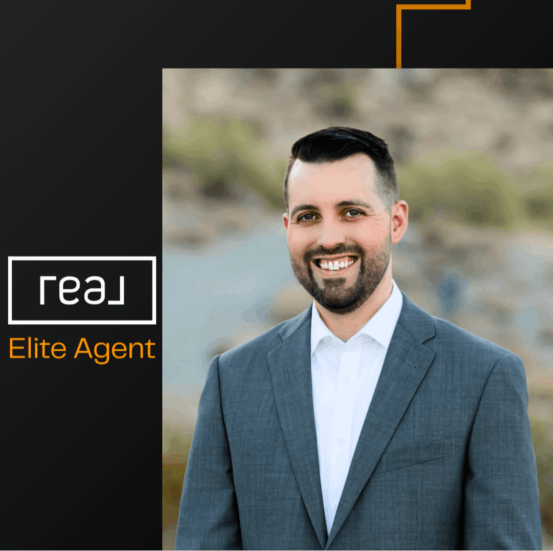 Eric Ravenscroft, Arizona real estate expert and Real Broker Elite Agent, professional headshot in a suit with desert background, top-rated Realtor in the Greater Phoenix Metro specializing in new construction, relocation, and investment properties.