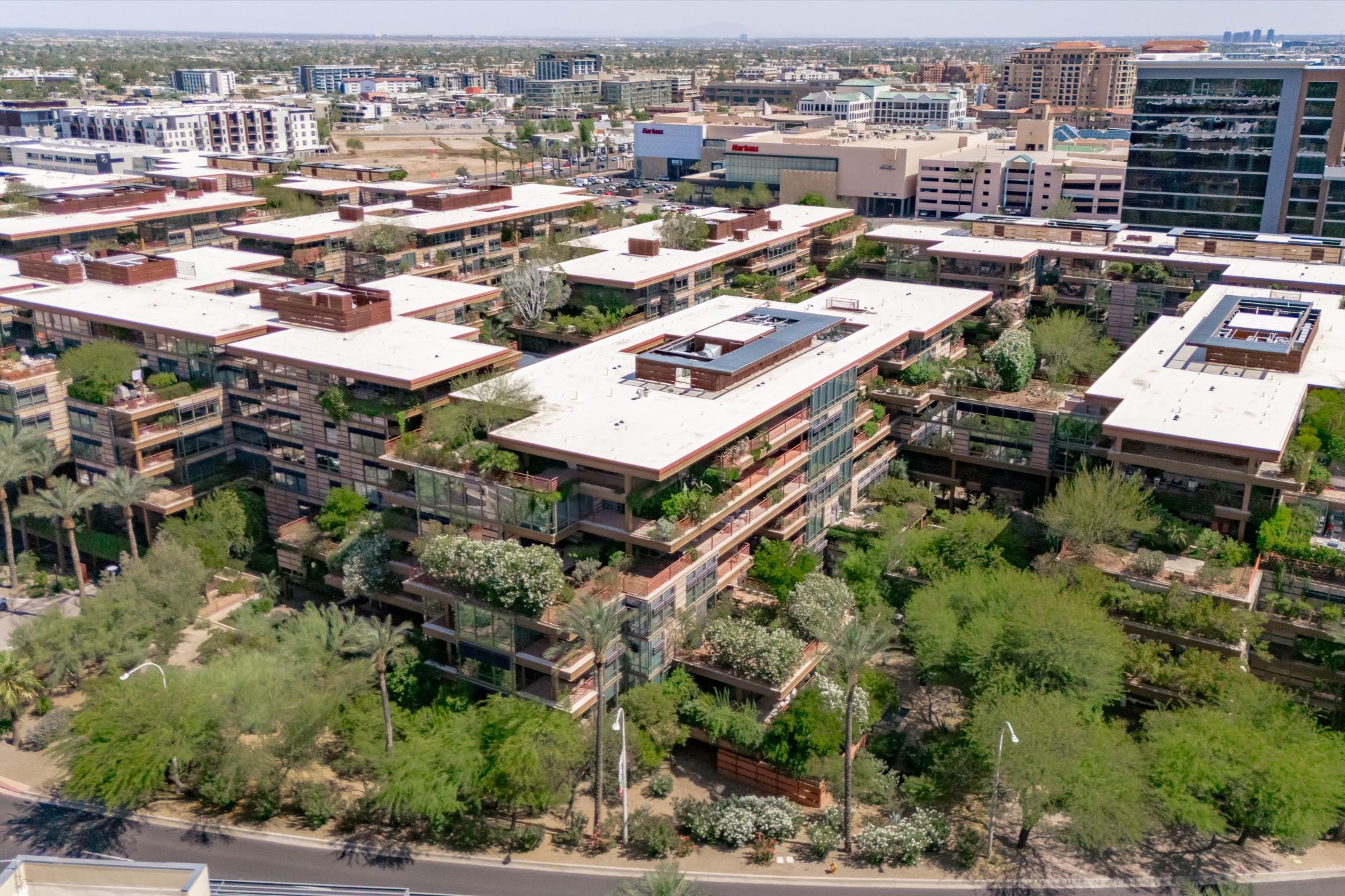 Aerial view of Optima Camelview Village luxury condo community in Scottsdale, AZ, featuring modern architecture, private terraces with lush landscaping, and rooftop gardens. Located near Scottsdale Fashion Square and Old Town, this high-demand community offers resort-style amenities, rental flexibility, and investment potential in one of the most walkable areas of Scottsdale.