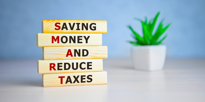 Stacked wooden blocks spelling SMART acronym for Saving Money and Reduce Taxes – tax planning and bonus depreciation strategy concept for real estate investors and high-income earners.