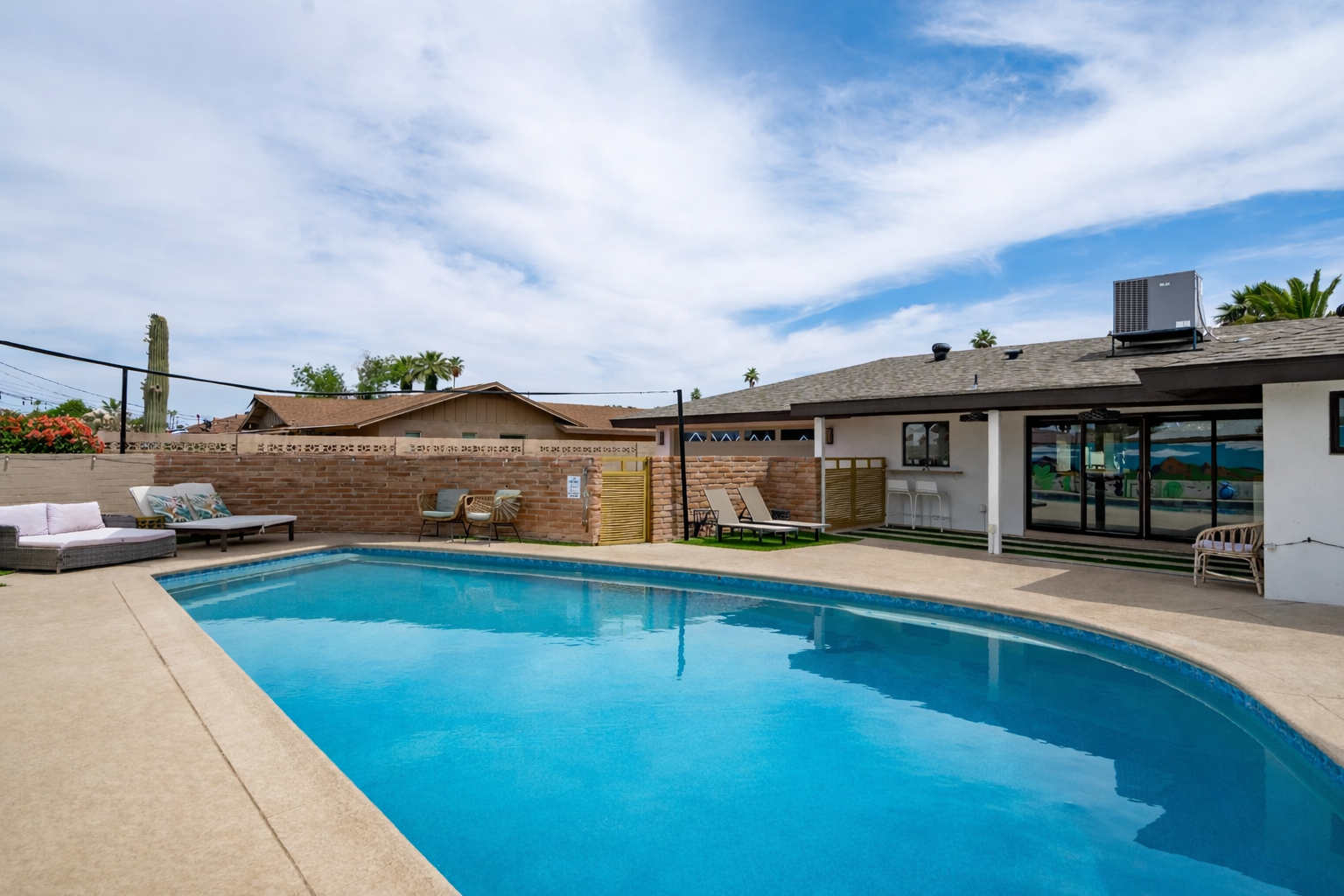 Resort-style backyard of a turnkey Old Town Scottsdale short-term rental featuring a private swimming pool, outdoor lounge seating, and guest-friendly outdoor living designed for high-performing vacation rental stays.