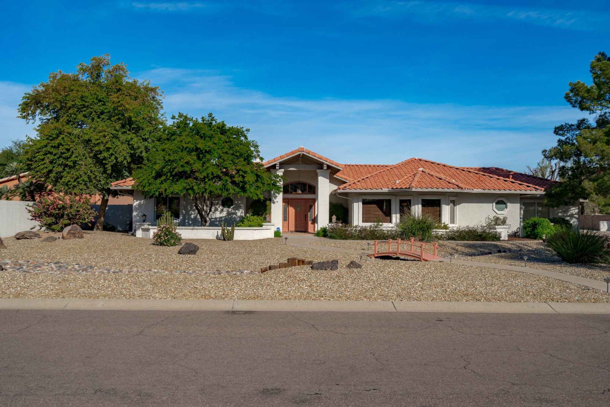Front exterior of Saddleback Foothills home in Glendale AZ featuring single-level design, desert landscaping, tile roof, and large lot with no HOA