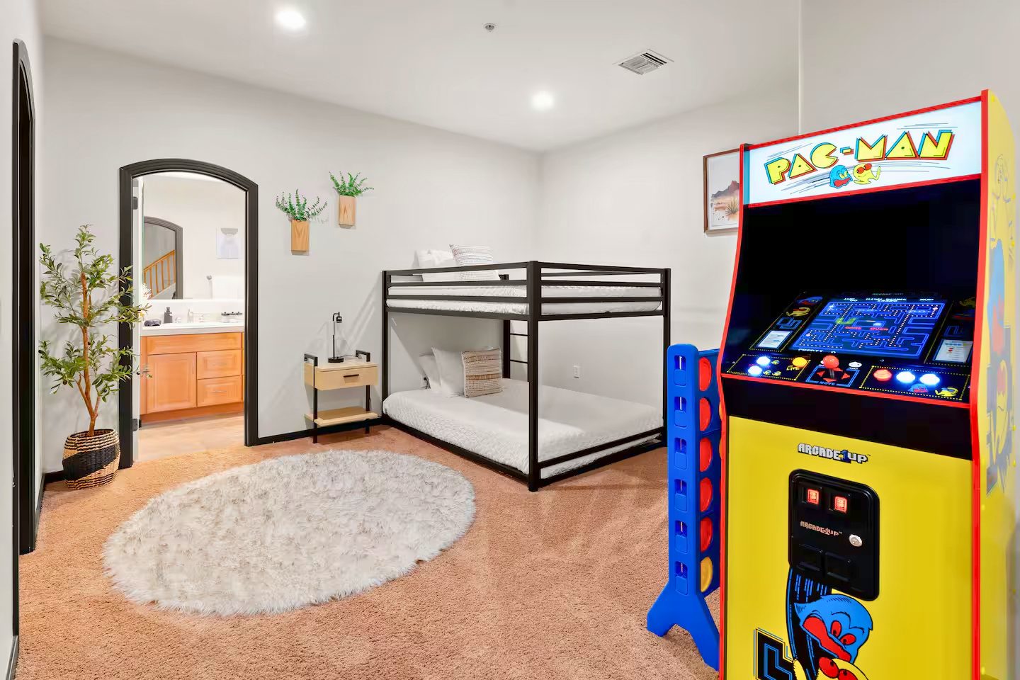Finished basement suite in Palm Valley Goodyear AZ short-term rental featuring bunk beds, arcade game, private bathroom access, and flexible multi-family layout—rare Phoenix basement design that increases occupancy, guest experience, and STR investment value.