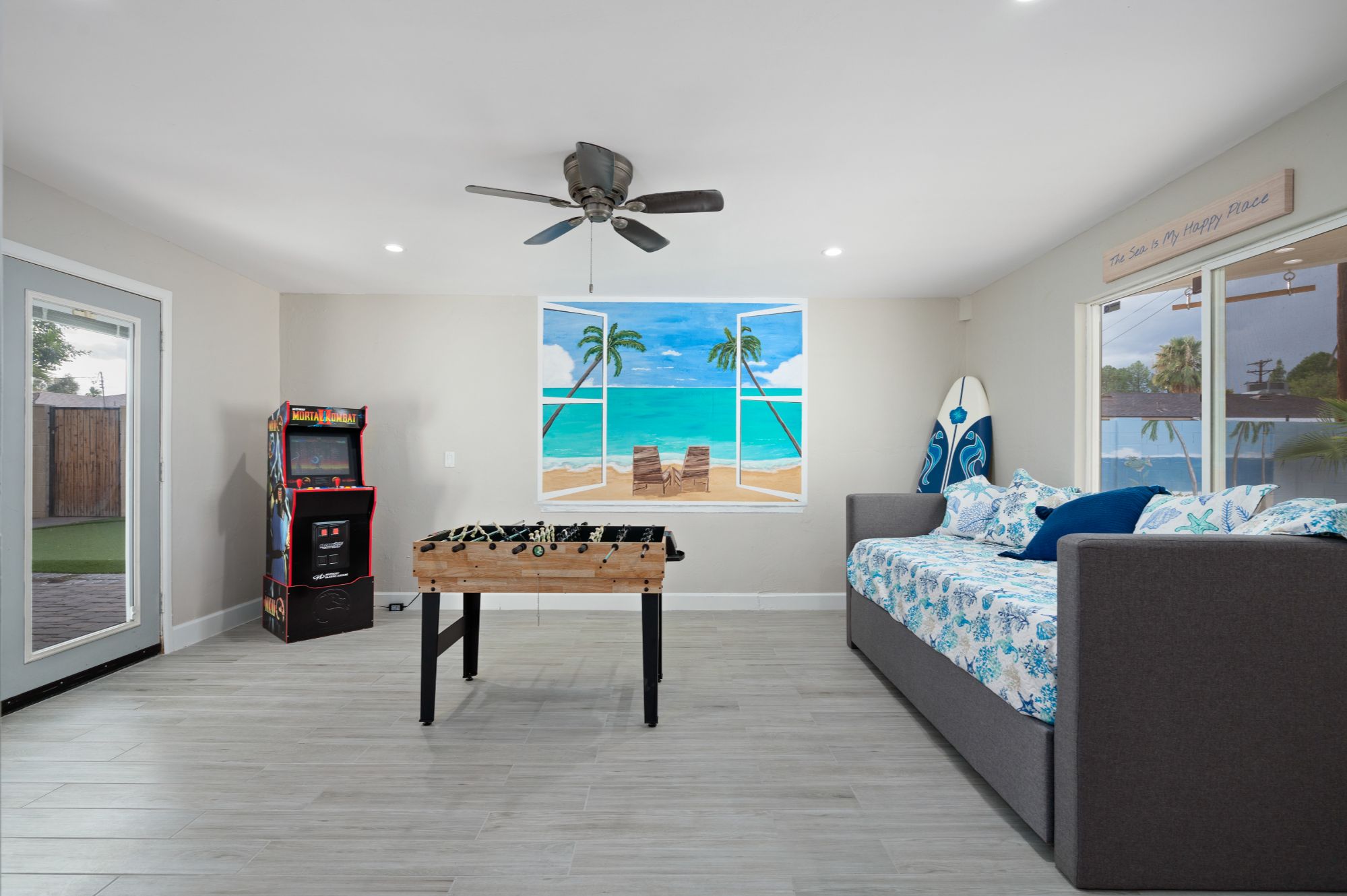 Scottsdale home bonus room with game area, foosball table, arcade machine, and additional sleeping space, ideal for increasing short-term rental occupancy and guest experience near Old Town Scottsdale