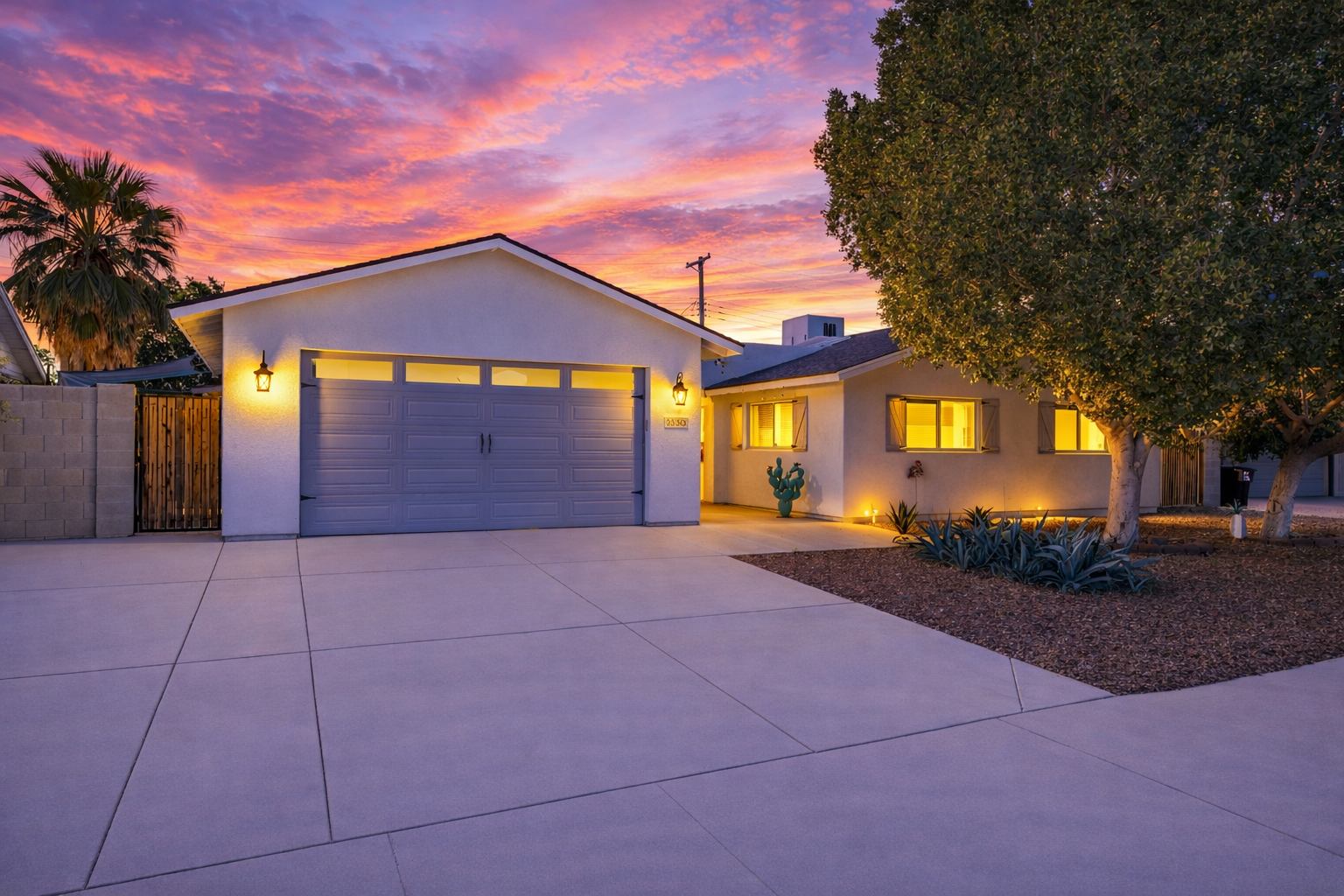 Turn-key Scottsdale Arizona home with modern exterior, two-car garage, and desert landscaping at sunset, ideal for primary residence, second home, or short-term rental investment near Old Town Scottsdale