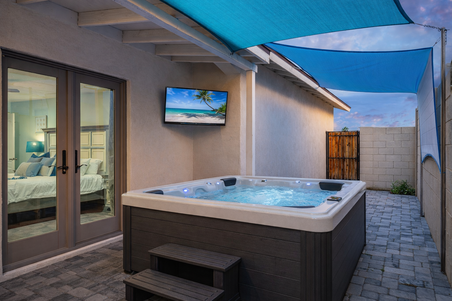 Luxury Scottsdale Airbnb backyard with private hot tub, outdoor TV, and covered patio, showcasing high-end amenities that drive higher nightly rates, guest satisfaction, and top-performing short-term rental success near Old Town Scottsdale