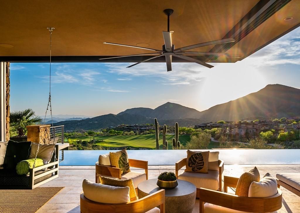 Luxury Scottsdale Arizona home with panoramic mountain and golf course views, featuring indoor-outdoor living and resort-style design ideal for high-end short-term rental investment and vacation home buyers