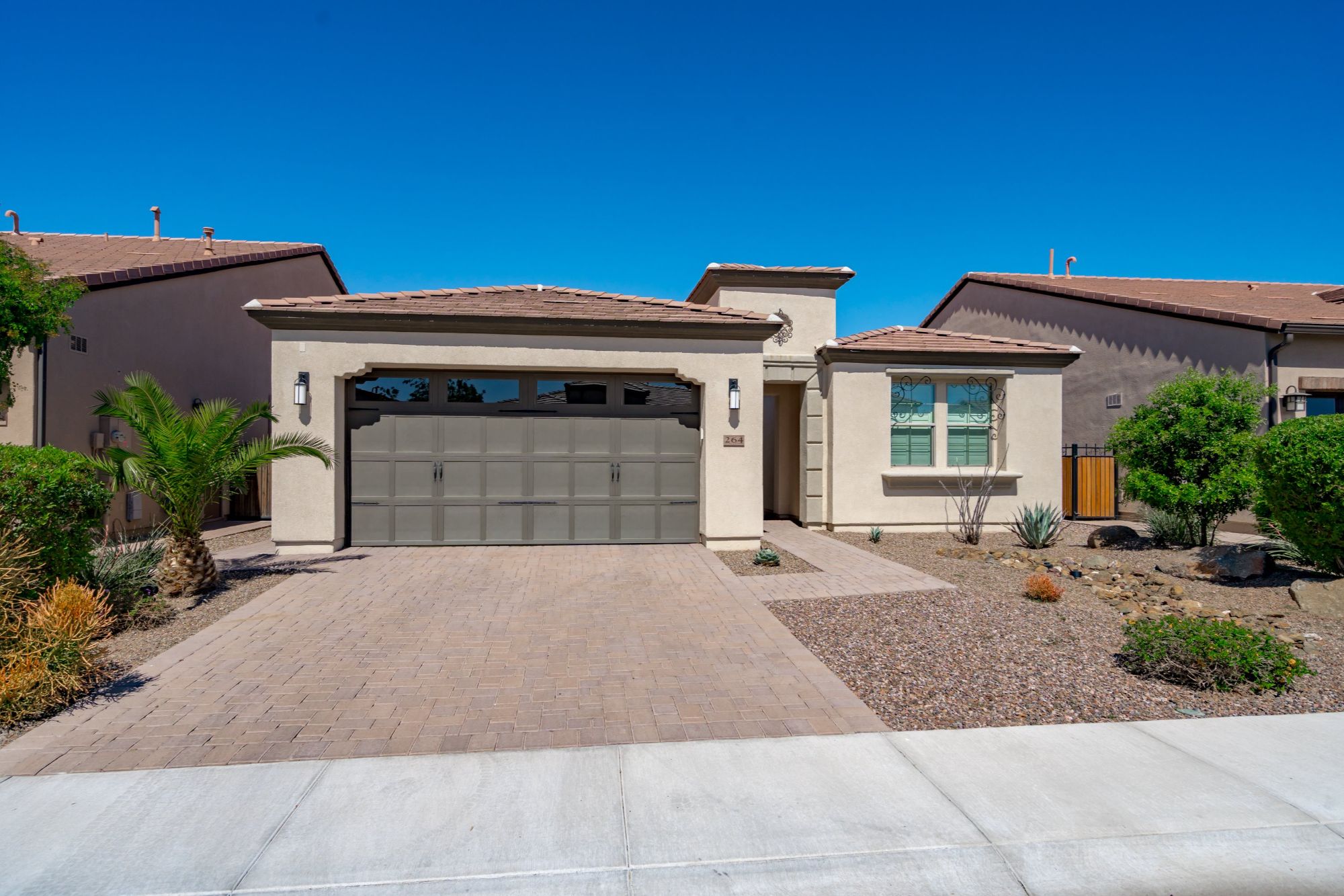Modern single-story home in Phoenix Arizona with low-maintenance desert landscaping and clean curb appeal, ideal for mid-term rental housing for traveling professionals, corporate relocation, and extended stays