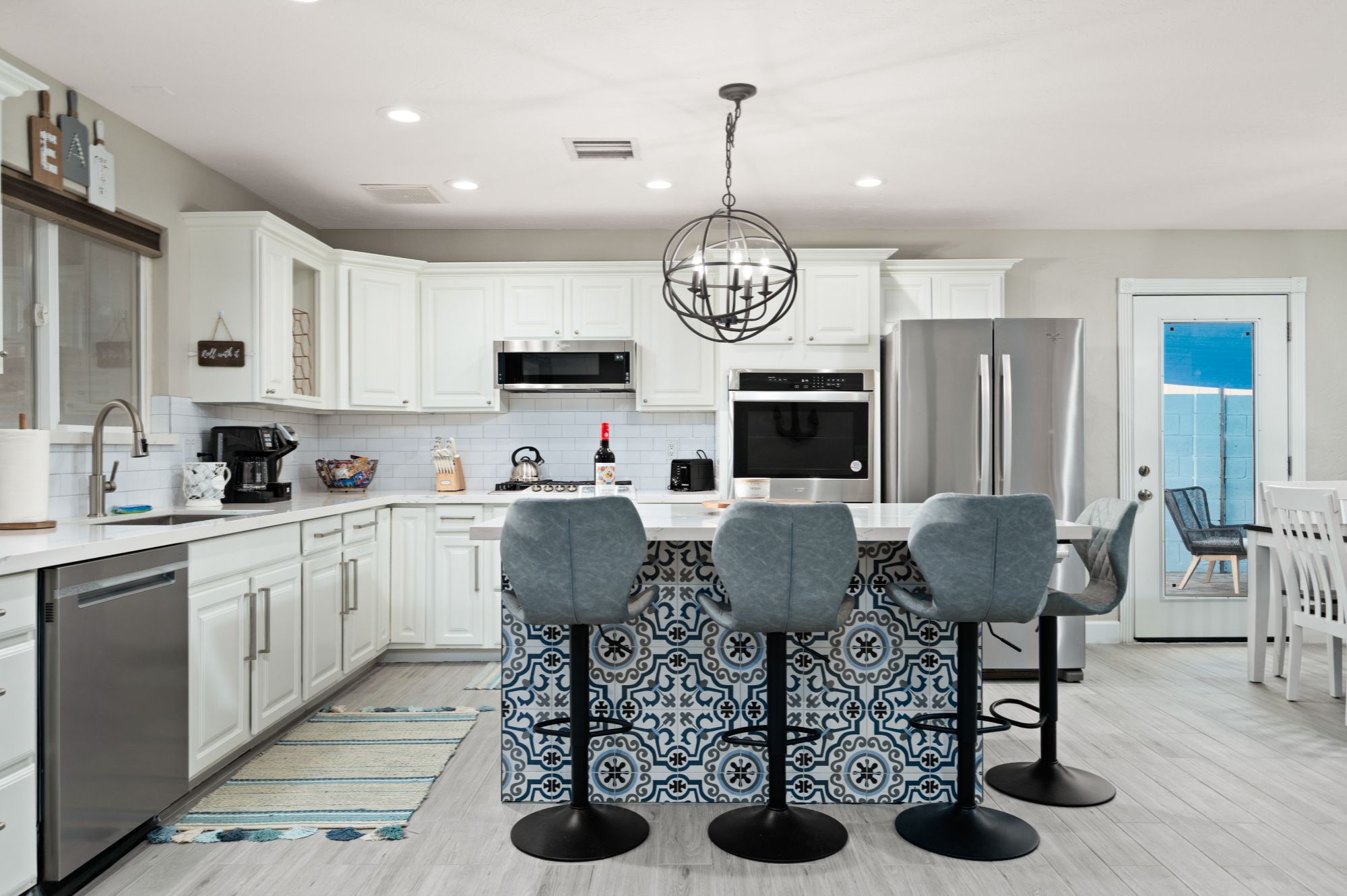Updated Scottsdale kitchen with modern white cabinets, large island seating, and open layout ideal for short-term or mid-term rental guests near Old Town Scottsdale with proven income performance