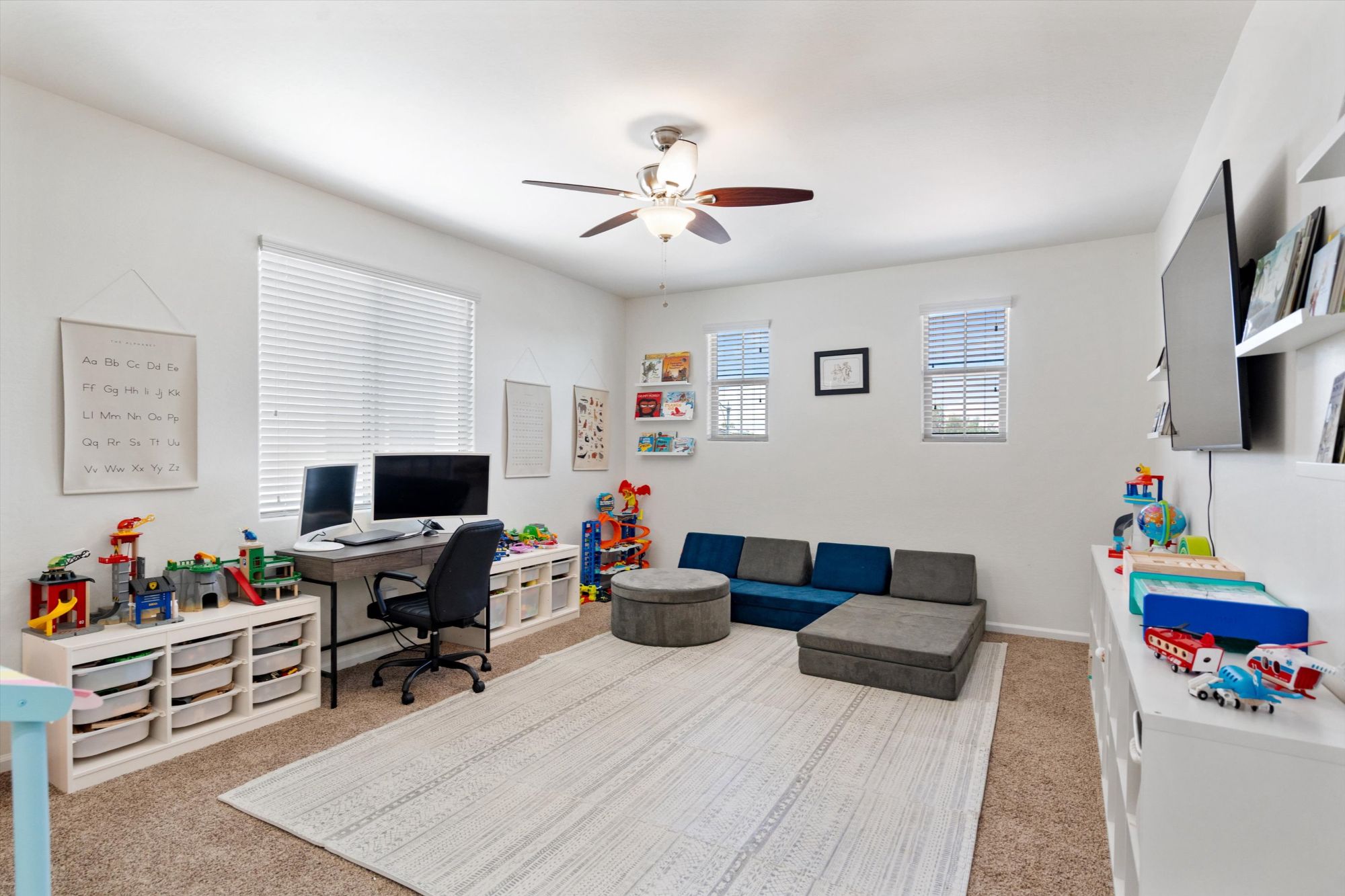 Bright, staged loft playroom and office space inside a Verrado Buckeye AZ home, showcasing flexible living areas and thoughtful presentation used to attract buyers when selling a home in the Verrado community.
