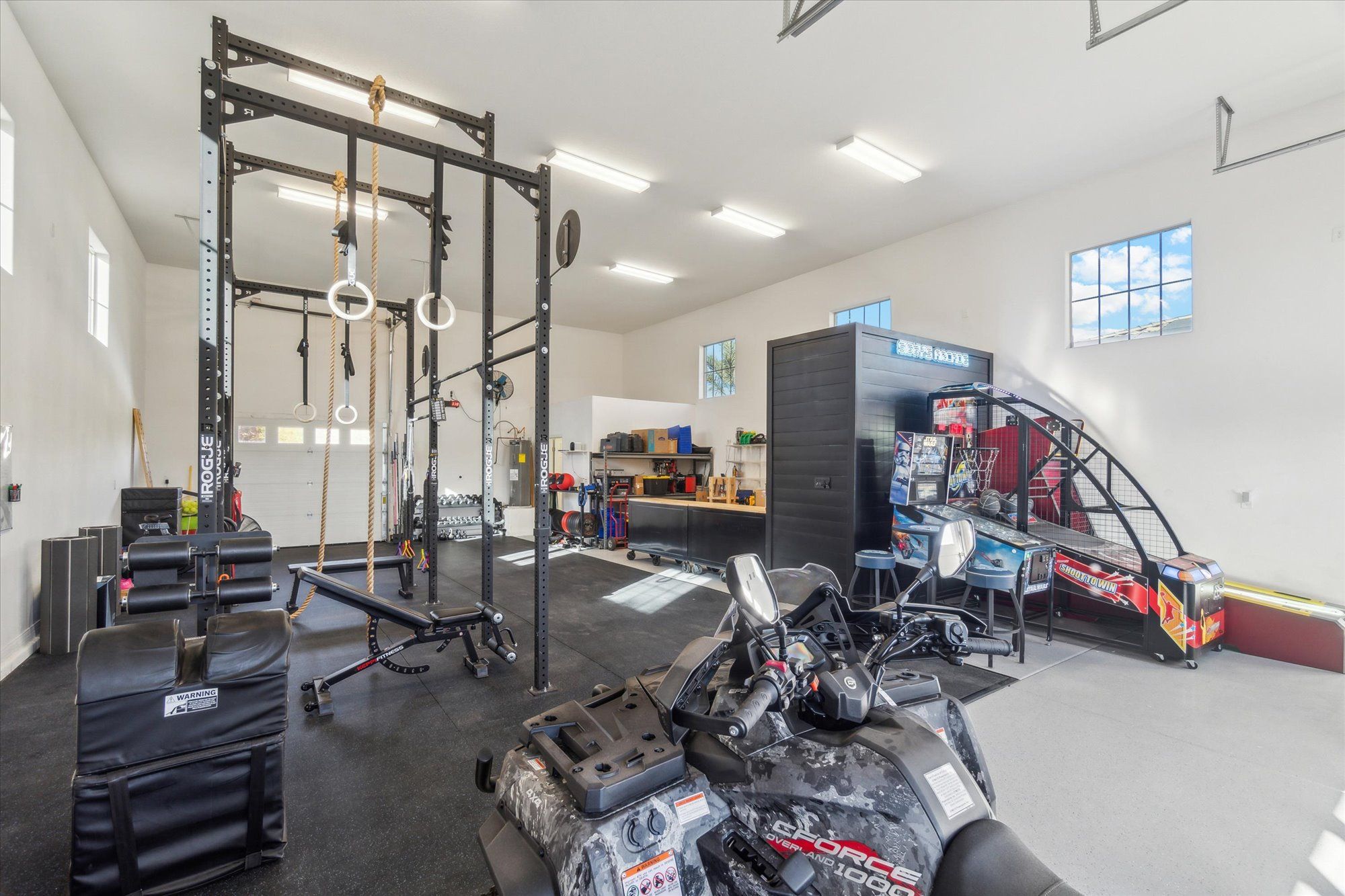 Large RV garage and flex space inside a North Peoria AZ luxury home featuring gym equipment and recreational area on a large estate lot