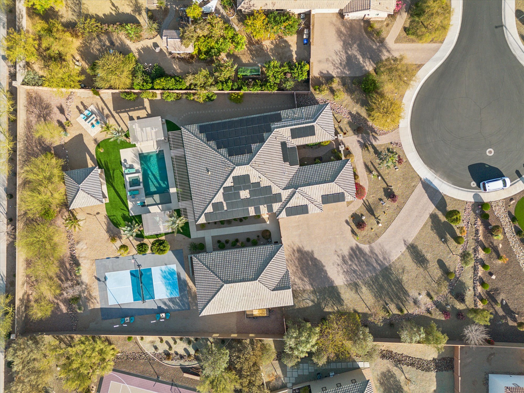Aerial view of a luxury home on a large estate lot in North Peoria AZ featuring resort-style pool, sport court, RV garage, and desert landscaping