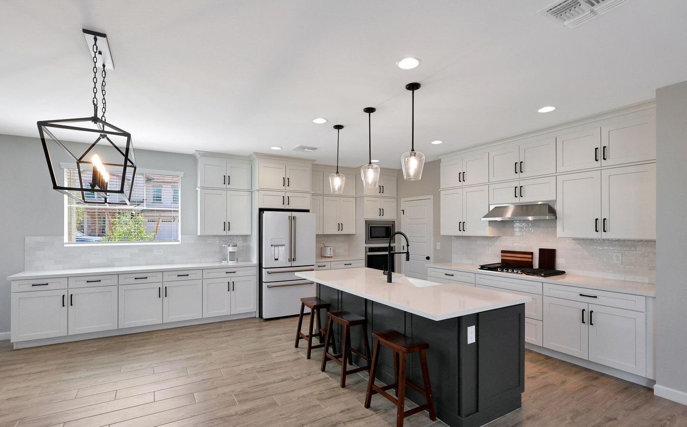 Modern kitchen with large island and upgraded finishes inside a Union Park at Norterra home in North Phoenix, Arizona, illustrating the type of newer construction property attracting tenants and investors seeking rental opportunities near the TSMC semiconductor campus.