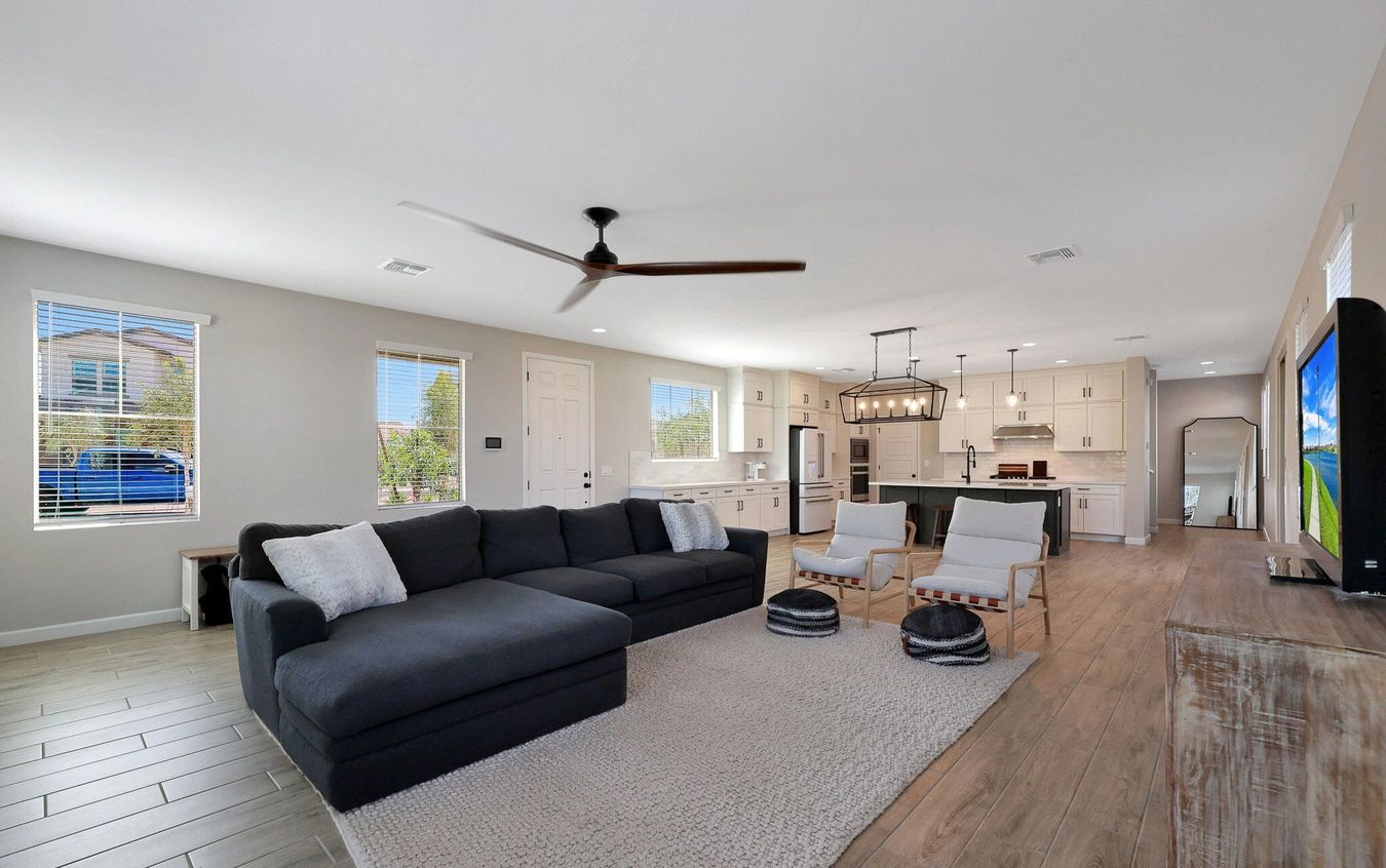 Open-concept living room and kitchen inside a modern Union Park at Norterra home in North Phoenix, Arizona, featuring contemporary finishes and spacious layout ideal for long-term rental demand from professionals working near the TSMC semiconductor campus.
