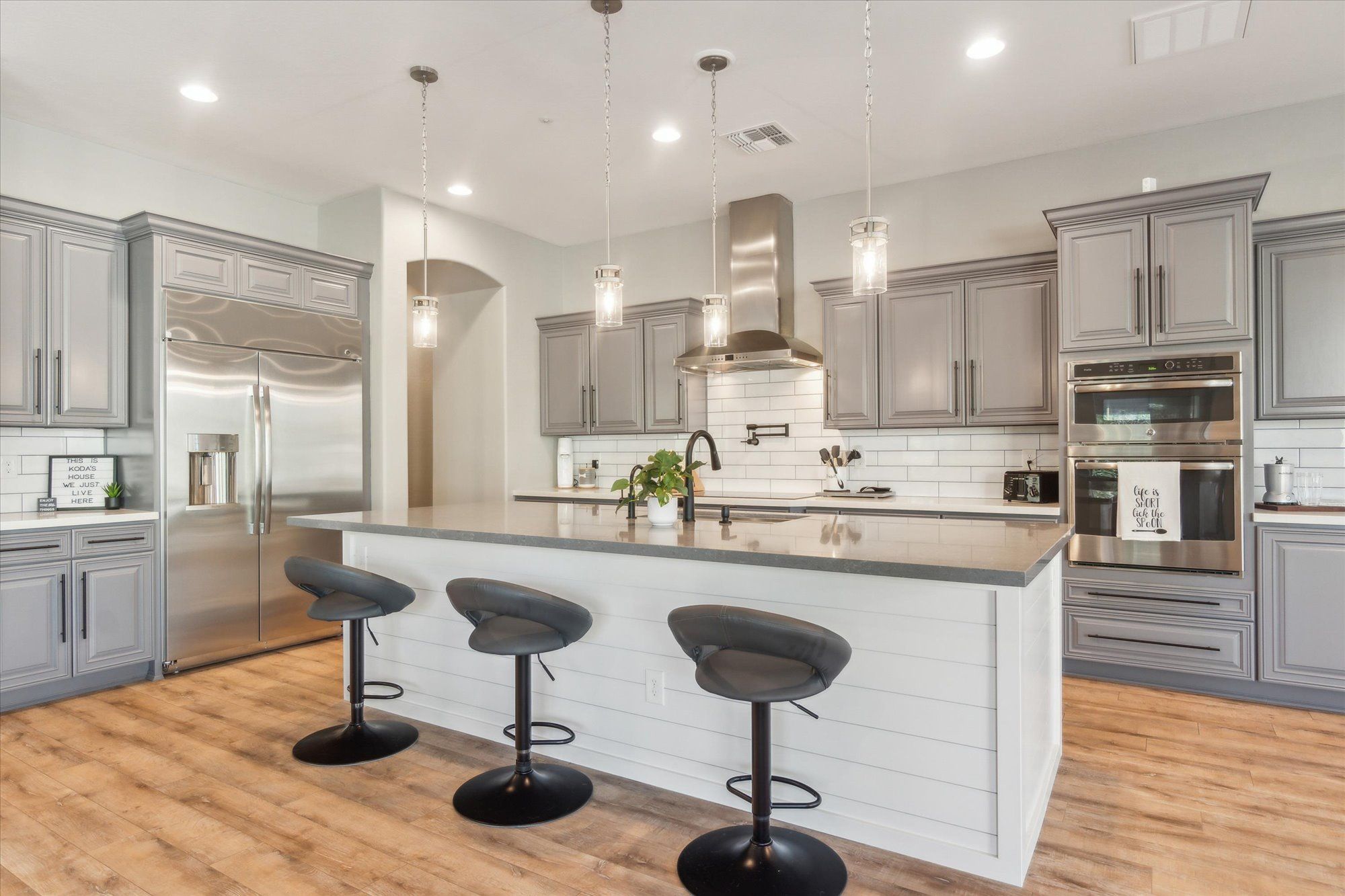 Well-staged short-term rental kitchen Arizona — hotel-quality STR setup with matching cookware and organized supplies