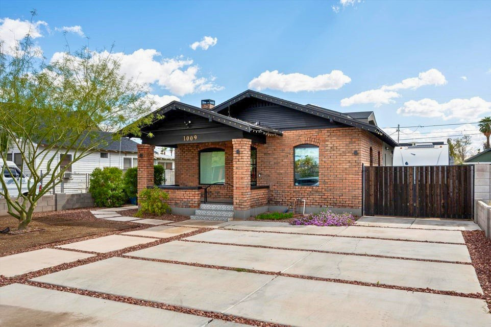 Exterior of 1009 E Garfield St, Phoenix — brick facade, mature landscaping, main residence and detached structures in the Garfield Historic District