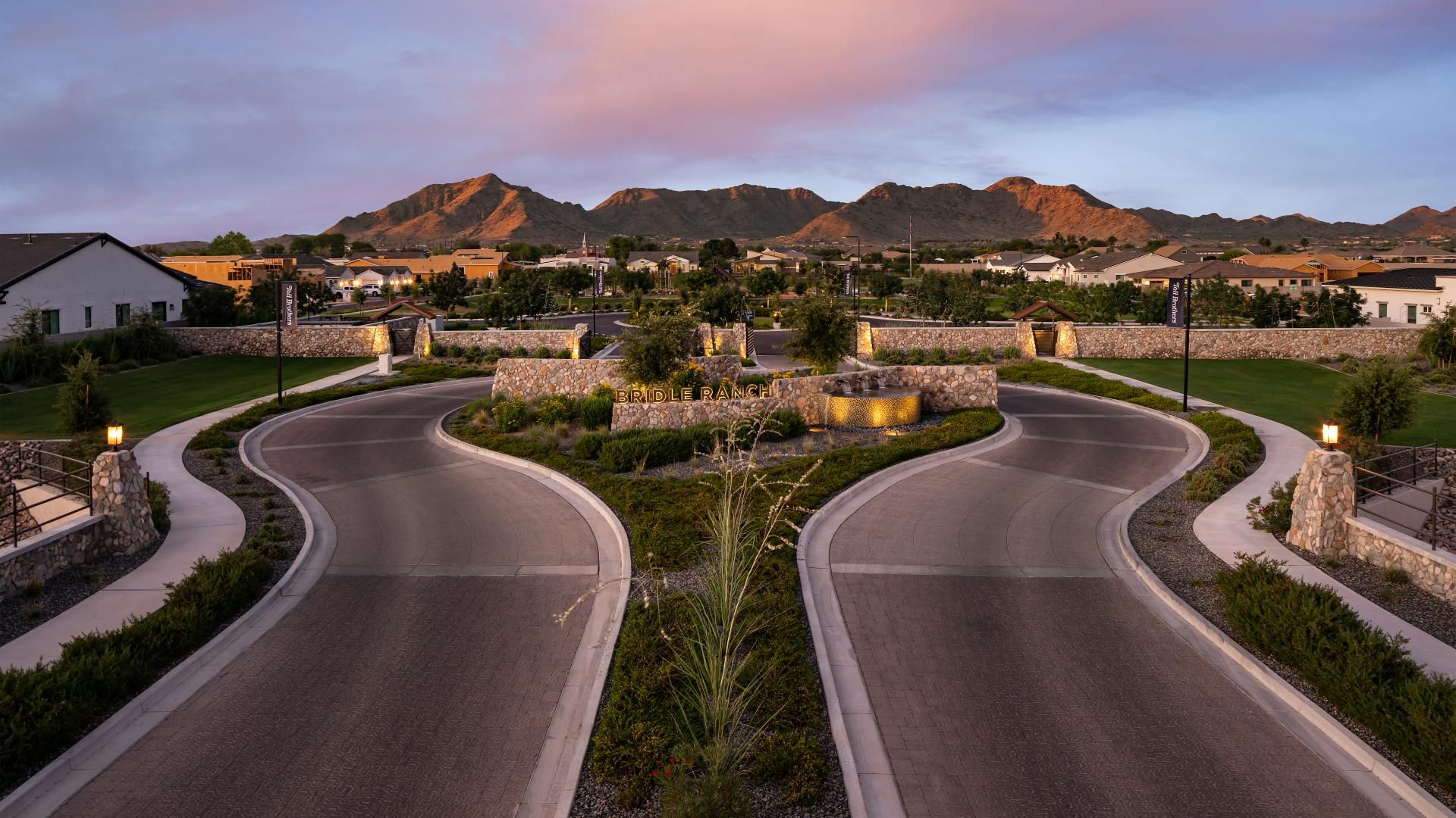 Gated HOA community entrance in the Phoenix Metro with landscaped signage and palm trees