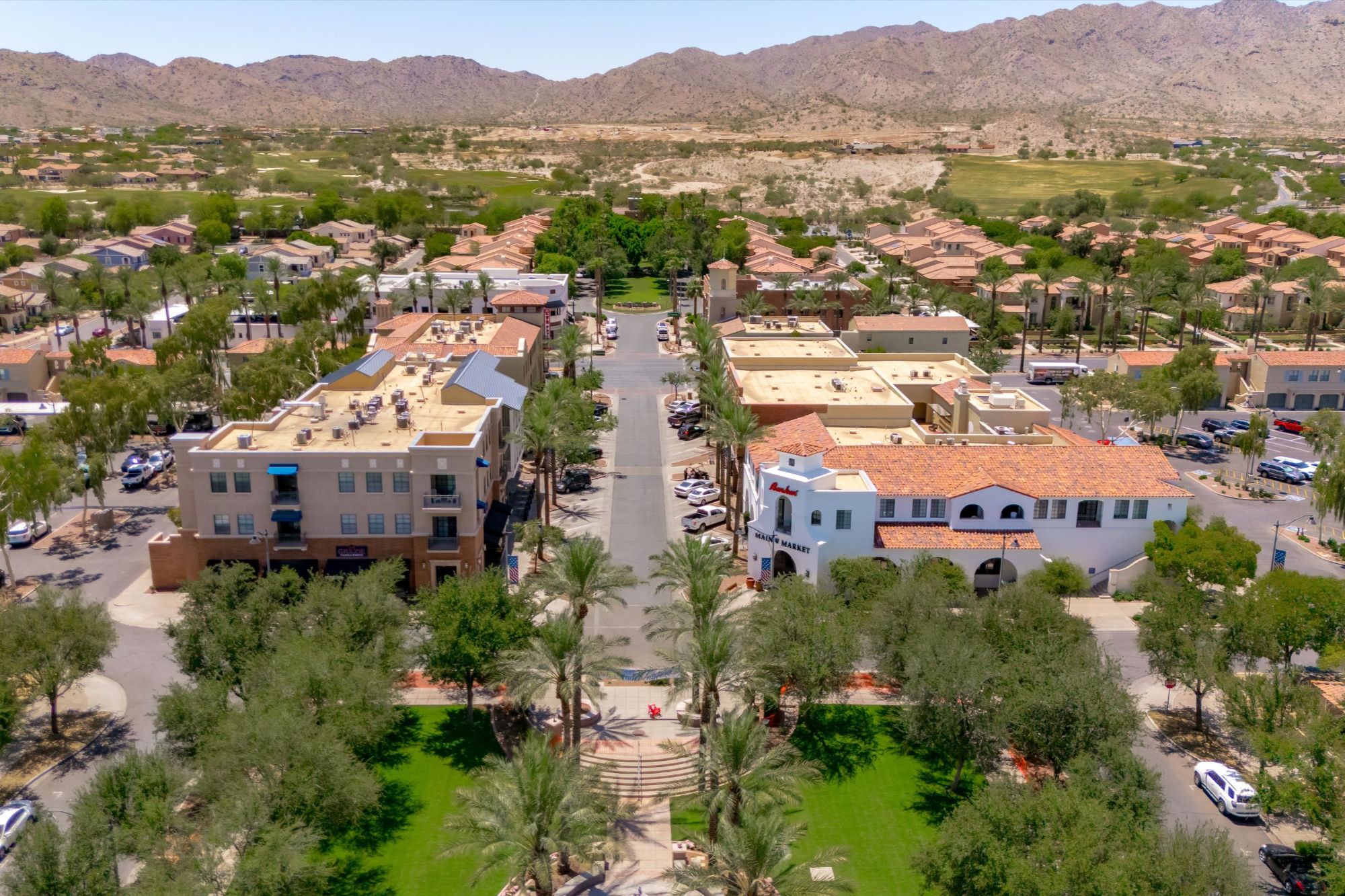 Aerial view of Verrado Main Street in Buckeye, Arizona showcasing the walkable town center and White Tank Mountains.