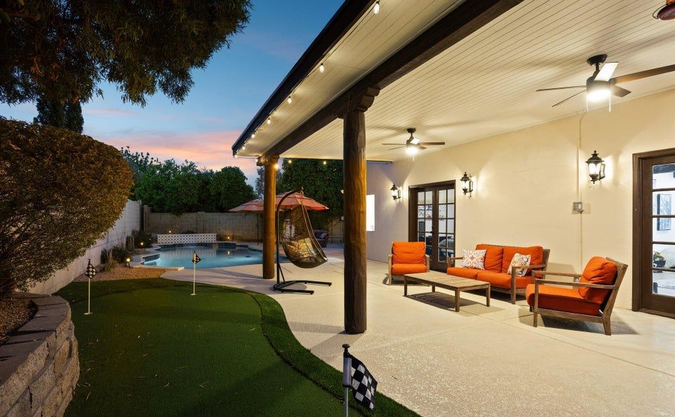 Patio, putting green, and pool at 14621 N 63rd Pl