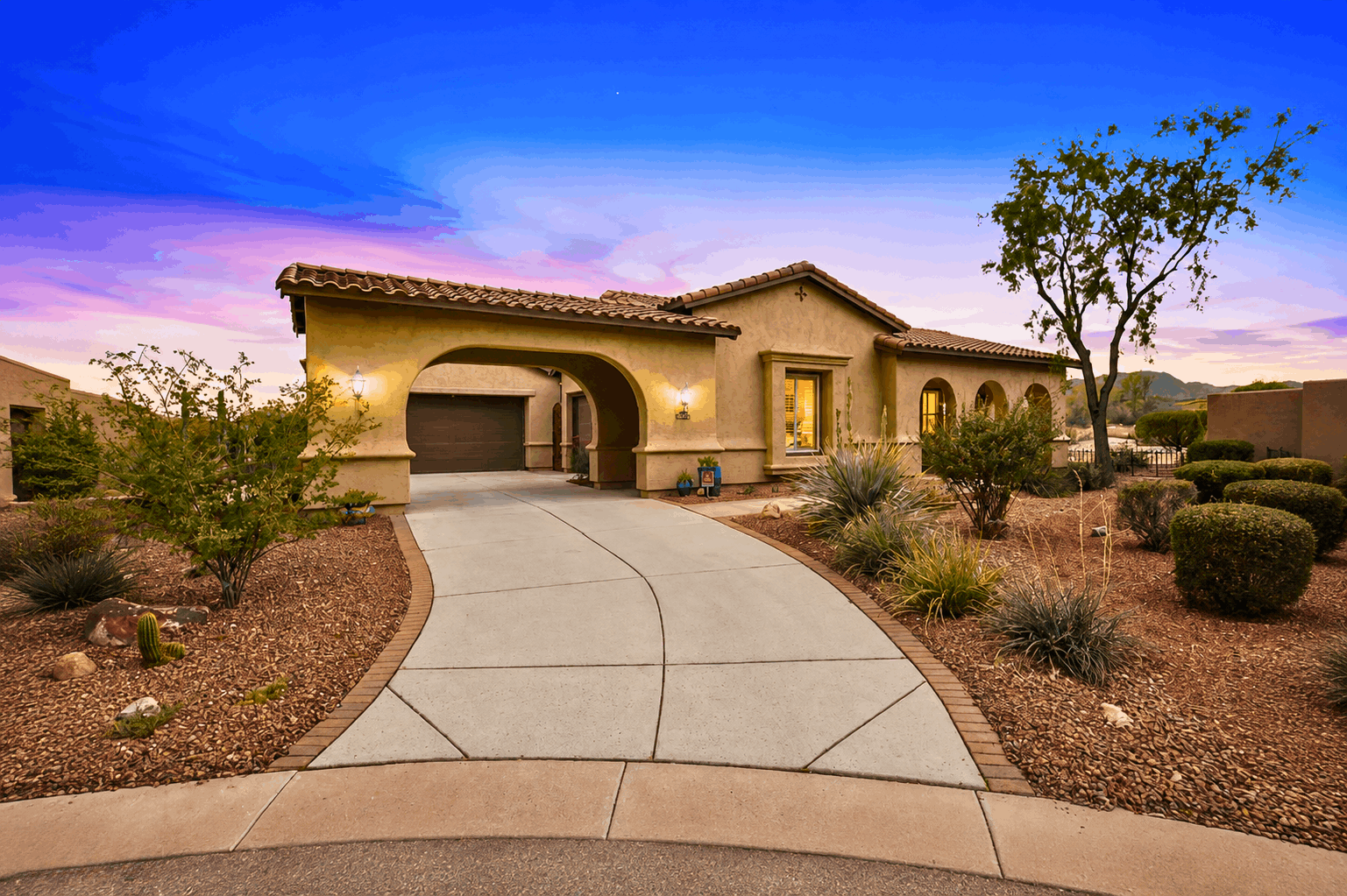 Front exterior of 21433 W Mule Deer Way with 3-car garage