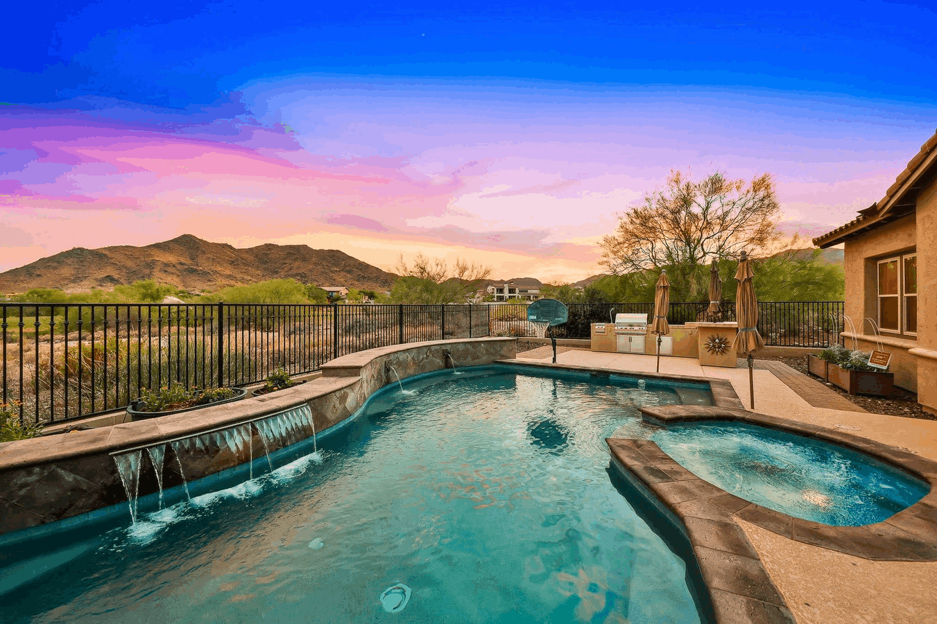 Backyard pool and spa with golf course and mountain views