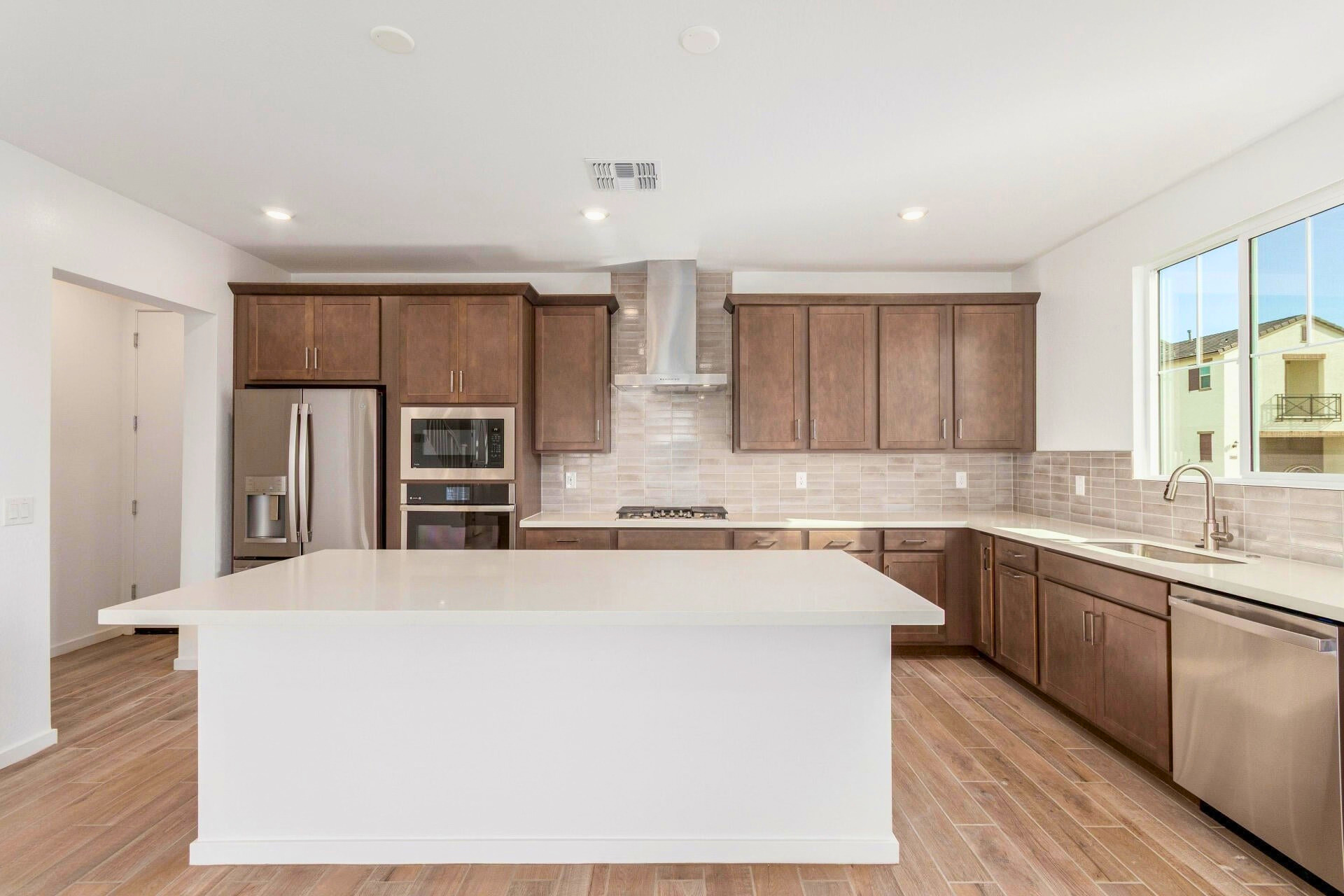 Gourmet kitchen with quartz island at 2488 W Rowel Rd, new build near TSMC in North Phoenix