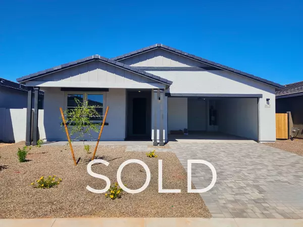 New construction home in a gated community in Surprise AZ with paver driveway and desert landscaping — sold by Eric Ravenscroft, Top 1% REALTOR® in the Greater Phoenix Metro.