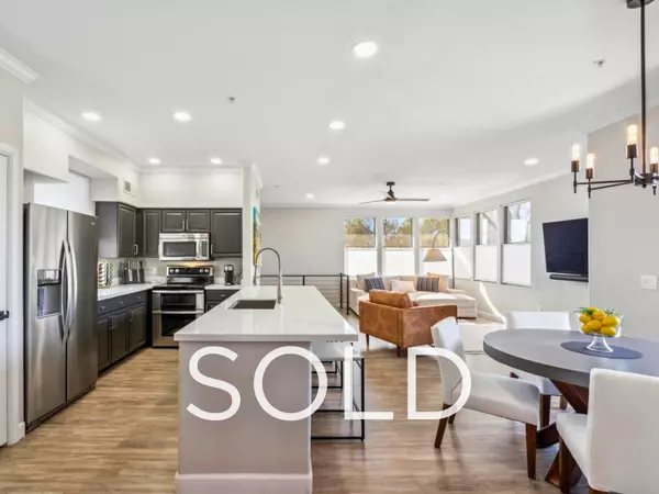 Sold Scottsdale condo interior featuring open-concept kitchen with quartz island, stainless steel appliances, modern cabinetry, and spacious living area—turn-key Scottsdale Arizona condo near Mayo Clinic with built-in equity and investment potential.
