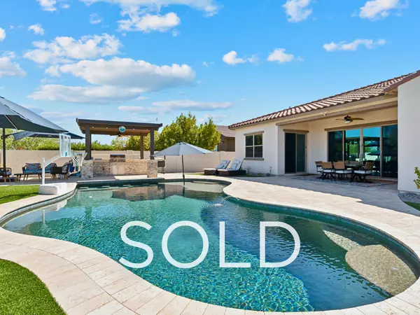 Sold Verrado Buckeye AZ home featuring resort-style backyard with pool, spa, outdoor kitchen, and covered patio—seller used buy-first strategy to move into gated Sedella community in Goodyear.
