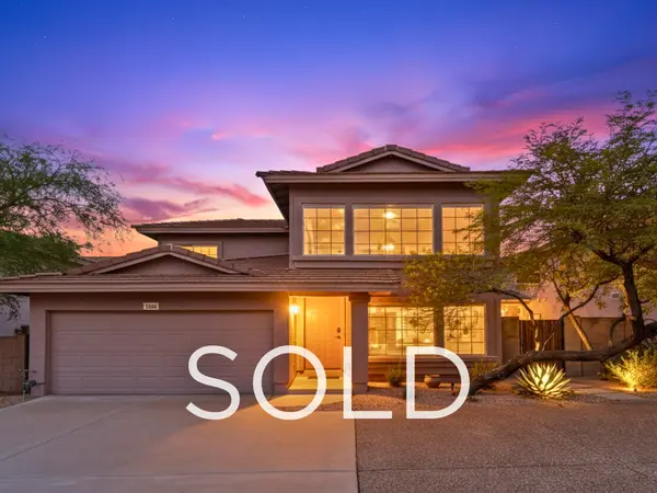 Sold North Scottsdale single-family home at 7650 E Williams Dr #1064 in a gated Scottsdale community, featuring twilight exterior photography, desert landscaping, and record-setting sale for a non-updated property in the Greater Phoenix Metro real estate market.