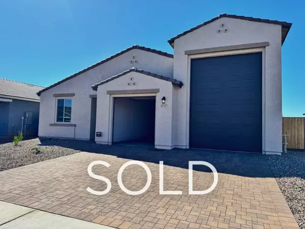 Sold new construction home in Waddell, Arizona featuring a rare RV garage and modern desert-style exterior, representing a successful client relocation purchase with long-term savings, builder incentives, and expert buyer representation in the Waddell AZ real estate market.