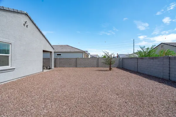 Arizona backyard with minimal landscaping and gravel lot illustrating how homes can blend into a competitive market without strategic presentation and positioning.