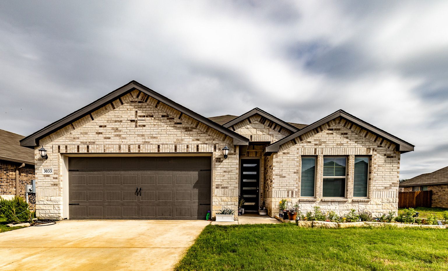 New construction home in Schertz TX — limestone and brick exterior typical of northeast San Antonio suburb homes near Randolph AFB
