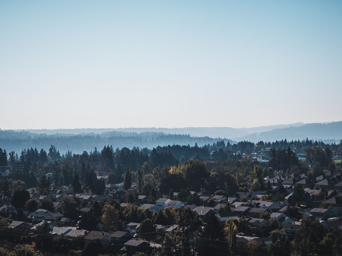 Aerial view of the Happy Valley, Oregon suburbs against forested hills