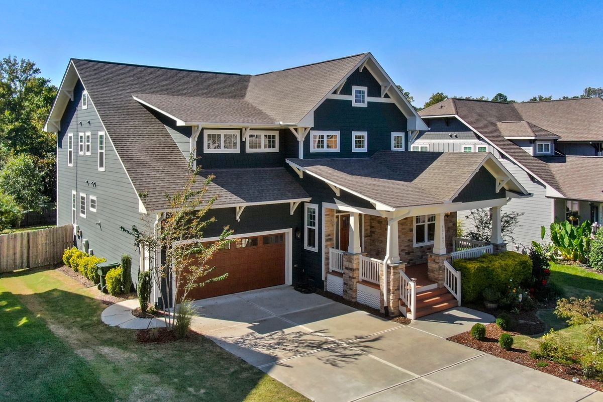 Craftsman-style home with a covered porch and front lawn