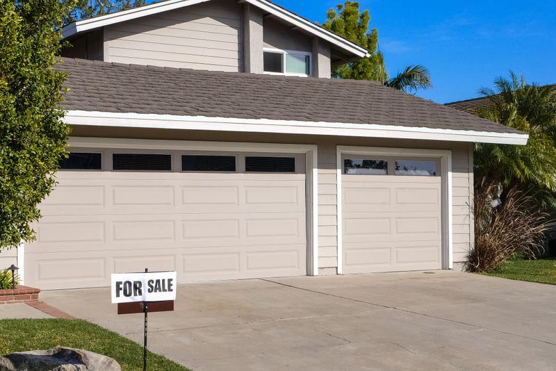 Suburban home with a for sale sign on the lawn