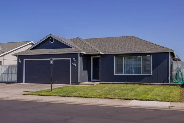 Single-story suburban home with a driveway and green lawn