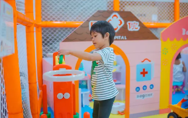 Child playing in a colorful indoor playground