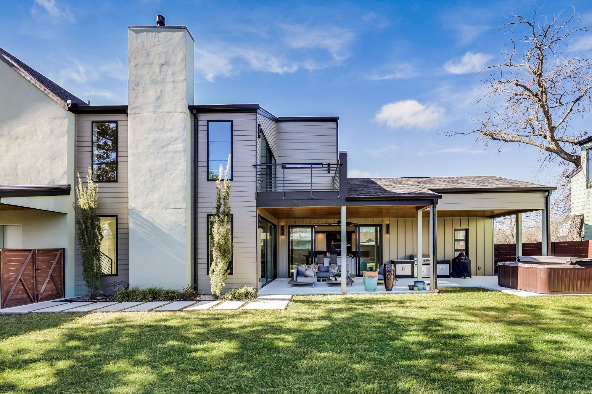 Covered outdoor patio with custom wood ceiling and large slider doors at 4600 Gillis.